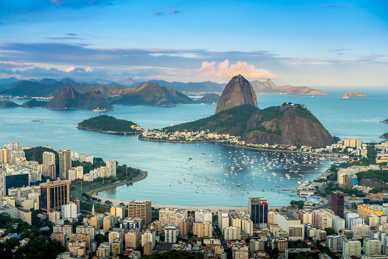 Pão de Açúcar e a baía de Botafogo com barcos, vistos do Morro Dona Marta ao entardecer.
